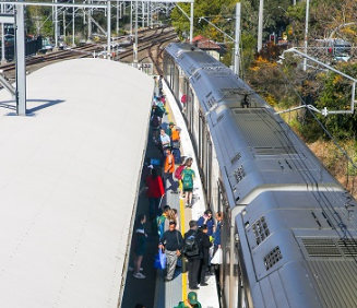 Image of passengers at a train station platform about to get onto a train that has just arrived.